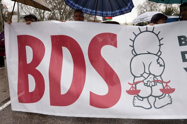 Protesters carry a banner with the acronym BDS (Boycott, Divestment, Sanctions) during a demonstration held in Madrid, Spain on March 8.