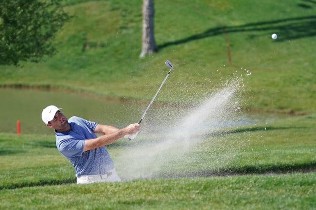 May 4, 2025; McKinney, Texas, USA; Scottie Scheffler plays a shot from a bunker on the 18th hole during the final round of the THE CJ CUP Byron Nelson golf tournament. Mandatory Credit: Raymond Carlin III-Imagn Images