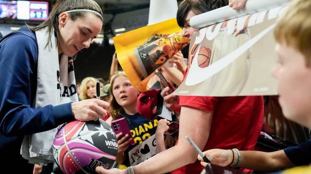 Caitlin Clark signs autographs after the Fever’s win.