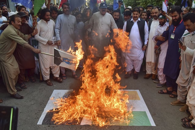 Supporters of Muttahida Qabail Federation party burn a rendition of the Indian flag and poster with the picture of Indian Prime Minister Narendra Modi during a demonstration in Quetta, Pakistan, Sunday, May 4, 2025. (AP Photo/Arshad Butt)