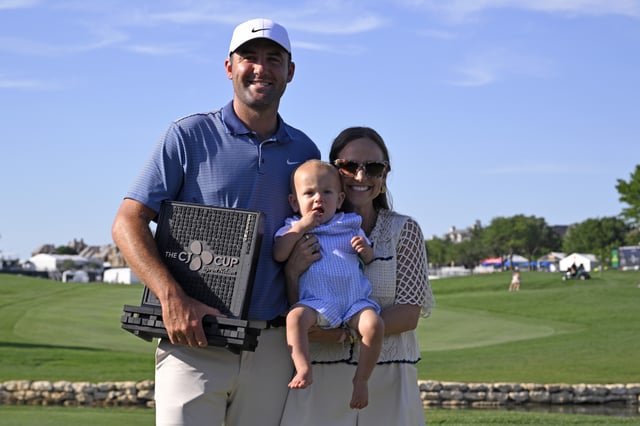 MCKINNEY, TEXAS - MAY 04: Scottie Scheffler of the United States poses with the winner&#39;s trophy alongside wife Meredith and son Bennett after the final round of THE CJ CUP Byron Nelson 2025 at TPC Craig Ranch on May 04, 2025 in McKinney, Texas. (Photo by Orlando Ramirez/Getty Images for The CJ Cup)
