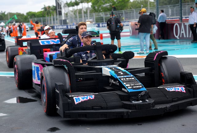 Formula One F1 - Miami Grand Prix - Miami International Autodrome, Miami, Florida, United States - May 4, 2025 Alpine's Pierre Gasly and Jack Doohan in a full sized Lego replica F1 car during the drivers parade REUTERS/Brian Snyder
