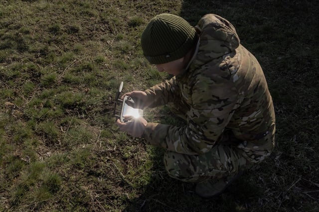 A Ukrainian military member of the State Border Guard Pomsta Brigade, Phoenix Drone Unit, performs a test flight of a Vampire hexacopter drone prior to his mission, in the Donetsk region, on March 19, 2025, amid the Russian invasion of Ukraine.