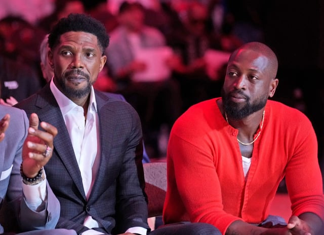 Former Miami Heat players Udonis Haslem (left) and Dwyane Wade, look on as the Heat commemorate the start of Heat president Pat Riley&#39;s 30th season with the franchise, during a halftime ceremony in an NBA basketball game between the Heat and the Orlando Magic, Wednesday, Oct. 23, 2024, in Miami. (AP Photo/Wilfredo Lee)