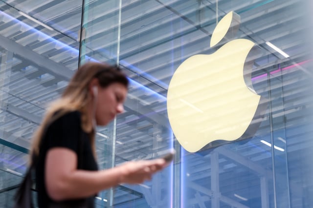 A person walks by the Apple store on Fifth Avenue in New York City, U.S., May 1, 2025. REUTERS/Kylie Cooper/File photo