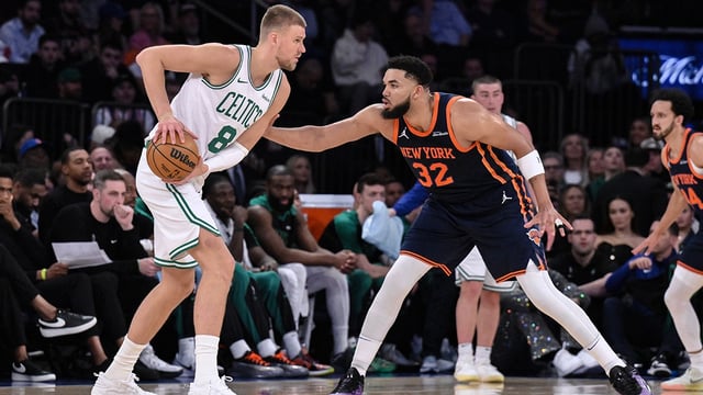 Apr 8, 2025; New York, New York, USA; Boston Celtics center Kristaps Porzingis (8) looks for an opening against New York Knicks center Karl-Anthony Towns (32) during the first half at Madison Square Garden. Mandatory Credit: John Jones-Imagn Images
