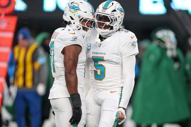 Jan 5, 2025; East Rutherford, New Jersey, USA; Miami Dolphins cornerback Jalen Ramsey (5) celebrates a defensive stop with linebacker Tyrel Dodson (11) during the first quarteragainst the New York Jets at MetLife Stadium. Mandatory Credit: Vincent Carchietta-Imagn Images/File Photo