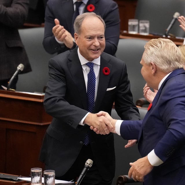 Ontario Premier Doug Ford, bottom right, shakes hands with Finance Minister Peter Bethlenfalvy, left, after he provided an economic update, which serves as a mini budget at Queen's Park, in Toronto, Wednesday, Oct. 30, 2024. THE CANADIAN PRESS/Nathan Denette