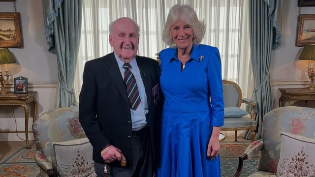 Douglas Cracknell with the Queen. He was wounded in the fighting in Normandy in 1944