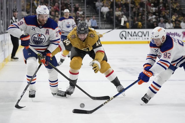 Edmonton Oilers centre Leon Draisaitl (29), Vegas Golden Knights defenceman Nicolas Hague (14) and Edmonton Oilers right wing Vasily Podkolzin (92) vie for the puck during the third period of an NHL hockey game Tuesday, April 1, 2025, in Las Vegas. The Oilers and Golden Knights meet in the second round of the 2025 NHL playoffs.  (AP Photo/John Locher)