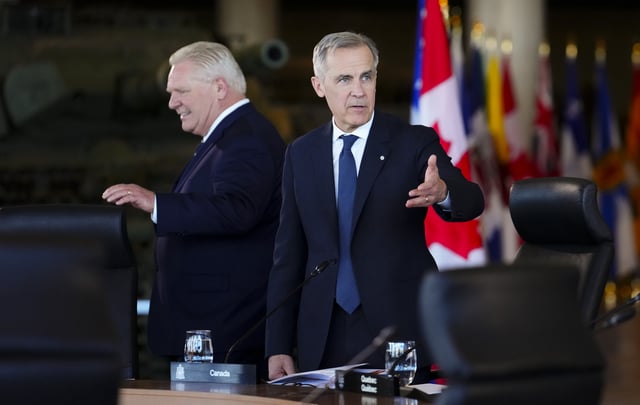 Doug Ford, Premier of Ontario, left and Prime Minister Mark Carney arrives to take part in the First Minister Meeting at the National War Museum in Ottawa on Friday, March 21, 2025. 