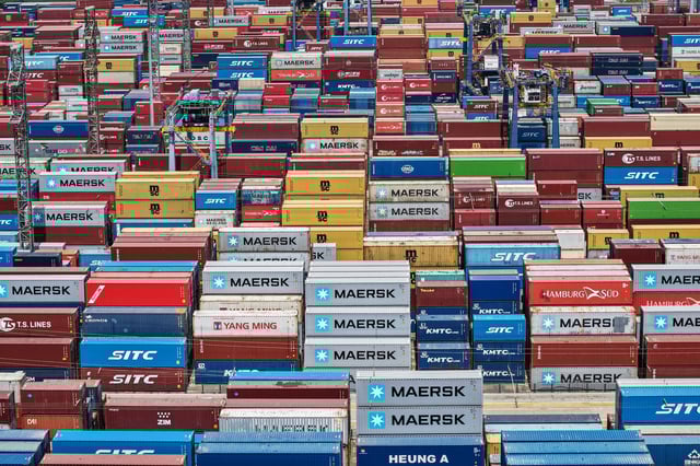 An aerial view shows cargo containers stacked at a port in Shanghai on April 20, 2025.