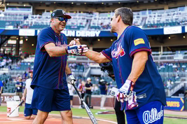 Ryan Klesko and Bret Boone shake hands during the Atlanta Braves Alumni Home Run Derby before the game between the Atlanta Braves and the Washington Nationals at Truist Park on August 24, 2024 in Atlanta, Georgia.