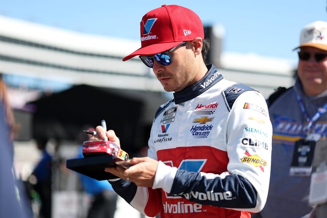 Kyle Larson, driver of the #5 Valvoline Chevrolet, signs autographs for NASCAR fans during practice for the NASCAR Cup Series Würth 400 at Texas Motor Speedway on May 03, 2025 in Fort Worth, Texas.