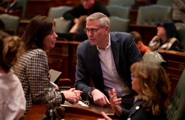 State Treasurer Michael Frerichs talks with legislators on the House floor at the state Capitol in Springfield on Jan. 7, 2025. (Brian Cassella/Chicago Tribune)