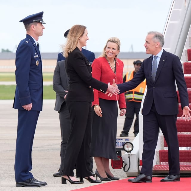 Prime Minister Mark Carney is greeted by Canadian Ambassador to the U.S. Kirsten Hillman, second left, U.S. Acting Chief of Protocol Abby Jones and U.S. Col. Randall J. Heusser as he disembarks a government plane Monday May 5, 2025  in Washington, D.C.