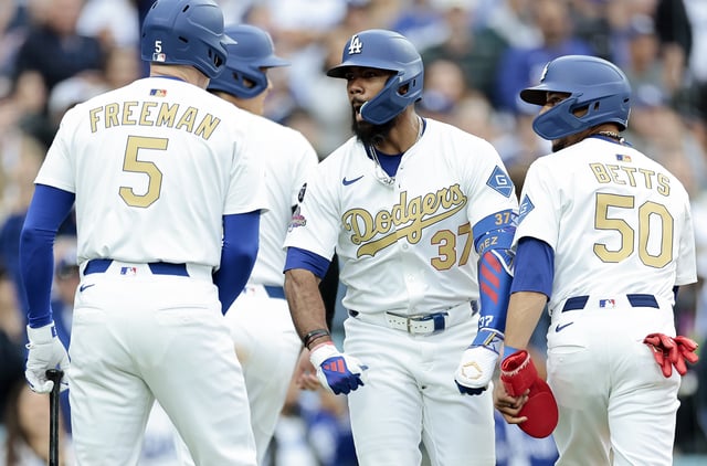 LOS ANGELES, CALIFORNIA - MARCH 27: Teoscar Hernández #37 celebrates with Freddie Freeman #5 Mookie Betts #50 and Shohei Ohtani #17 of the Los Angeles Dodgers after hitting a three-run home run in the fifth inning against the Detroit Tigers on Opening Day at Dodger Stadium on March 27, 2025 in Los Angeles, California.