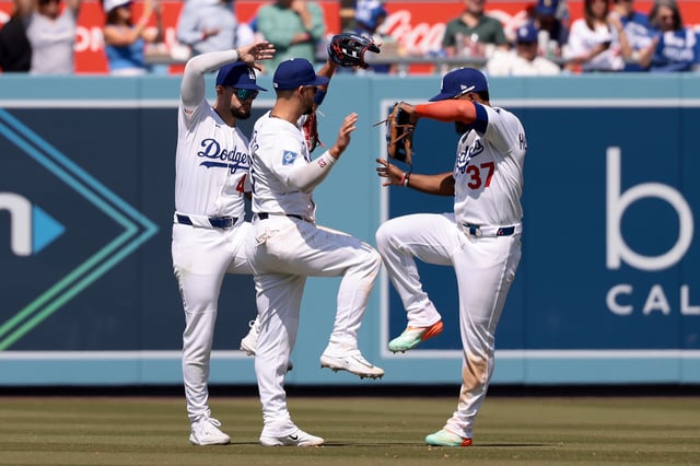 Andy Pages #44, Michael Conforto #23 and Teoscar Hernández #37 of the Los Angeles Dodgers celebrate after the 12-7 win against the Miami Marlins at Dodger Stadium on April 30, 2025 in Los Angeles, California.