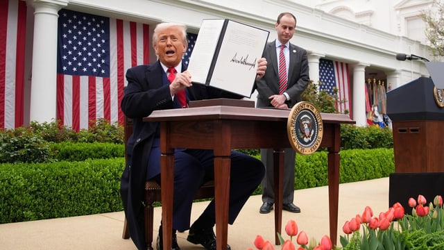 President Trump displays a signed executive order imposing tariffs on imported goods on April 2, which he called “liberation day”