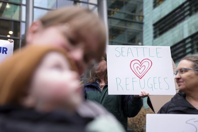 FILE - People gather outside the U.S. District Court after a federal judge blocked President Donald Trump's effort to halt the nation's refugee admissions system Feb. 25, 2025, in Seattle. (AP Photo/Ryan Sun, File)