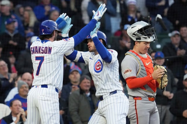 Chicago Cubs’ Ian Happ, center, celebrates with Dansby Swanson (7) after hitting a two-run home run as San Francisco Giants catcher Patrick Bailey reacts during the third inning of a baseball game in Chicago, Monday, May 5, 2025. (AP Photo/Nam Y. Huh)