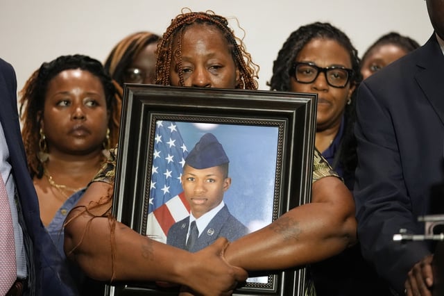 FILE - Chantemekki Fortson, mother of Roger Fortson, holds a photo of her son during a news conference, May 9, 2024, in Fort Walton Beach, Fla. (AP Photo/Gerald Herbert, File)