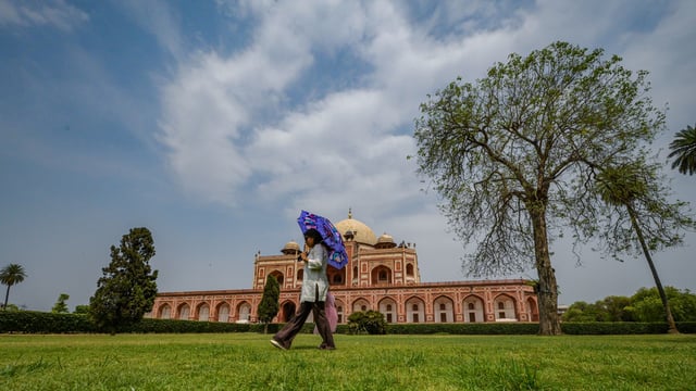 People enjoy the pleasant weather under the sky at Humayun's Tomb in New Delhi on Saturday. 