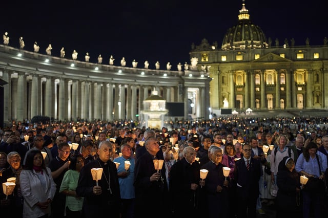 In the foreground center to right: Cardinal Mauro Gambetti, Cardinal Dean Giovanni Battista Re, and Cardinal Lazarus You Heung-sik attend a rosary prayer and a candlelight procession with the image of Mater Ecclesiae in St. Peter's Square at the Vatican, Saturday, May 3, 2025. (AP Photo/Bernat Armangue)