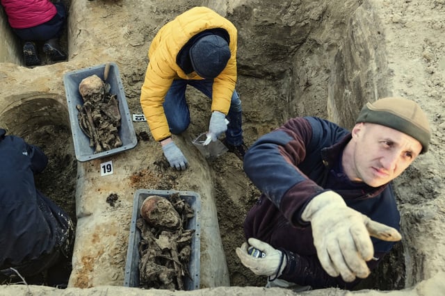 Workers of the German War Graves Commission exhume the remains of German WWII soldiers in Ostrołęka, Poland, Wednesday, March 19, 2025. (AP Photo/Czarek Sokolowski)