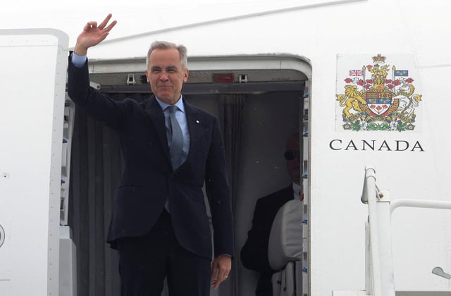 Canada's Prime Minister Mark Carney waves as he boards his plane for Washington, D.C., in Ottawa, Ontario, Canada, May 5, 2025.  REUTERS/Patrick Doyle/File Photo
