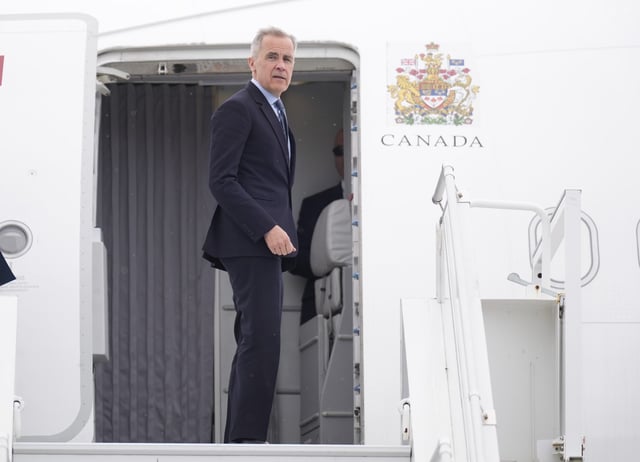 Prime Minister Mark Carney boards a government plane Monday, May 5, 2025. Carney is flying to Washington for a meeting with President Donald Trump on Tuesday. THE CANADIAN PRESS/Adrian Wyld