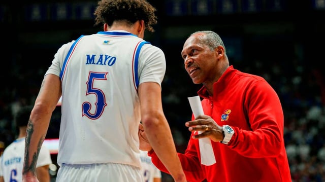 Kansas Jayhawks assistant men’s basketball coach Norm Roberts talks to guard Zeke Mayo during a February against the Iowa State Cyclones at Allen Fieldhouse.