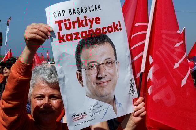 A person holds a placard during a rally to protest against the arrest of Istanbul Mayor Ekrem Imamoglu as part of a corruption investigation, in Istanbul, Turkey, March 29, 2025. REUTERS/Umit Bektas/File Photo