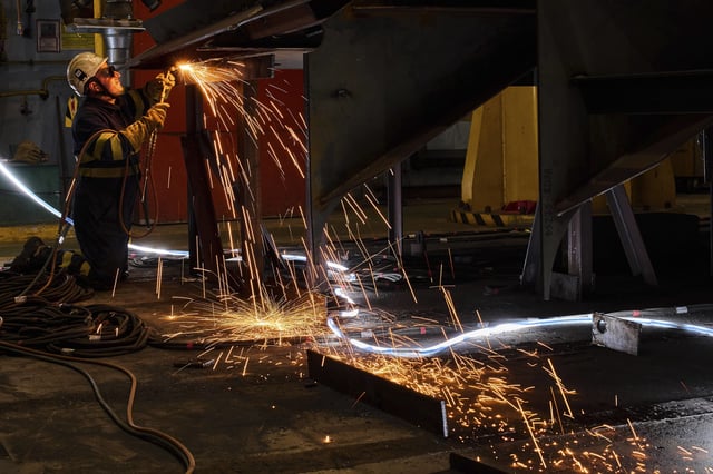 FILE - A worker welds a section of the F-111 class frigate's fuselage at a workshop in the Navantia shipyard in Ferrol, northwest Spain, on April 10, 2025. (AP Photo/Bernat Armangue, File)