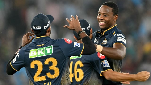 Gujarat Titans' Kagiso Rabada (R) celebrates with teammates