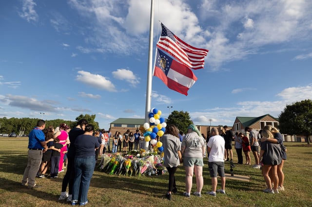 Students and community members make a prayer circle around a makeshift memorial outside Apalachee High School on September 5, 2024, in Winder, Georgia.