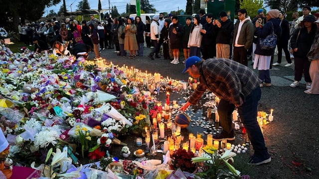 People gather at a memorial in Vancouver on April 28, 2025, in honour of those who were killed and injured when an SUV drove through a crowd at the Lapu-Lapu Day Filipino festival. 