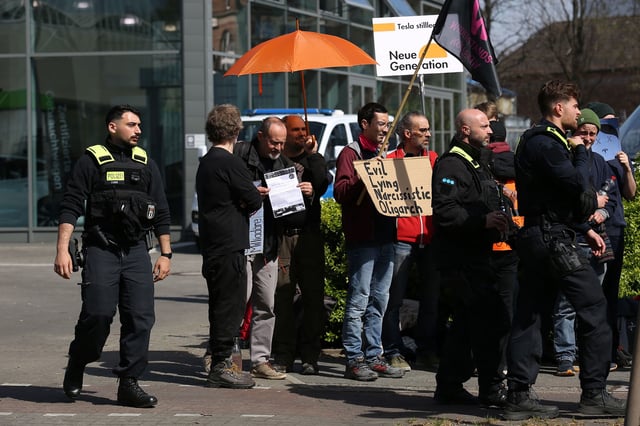Activists of the Tesla Takedown movement protest outside a Tesla electric car showroom in Berlin, Germany. In Germany, many people are opposed to Tesla company owner Elon Musk's outspoken support of the far-right Alternative for Germany (AfD) political party.