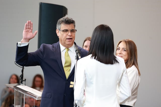 Orlando District 2 Commissioner Tony Ortiz, alongside his family, is sworn in by his daughter Hazel Ortiz during an Oath of Office Ceremony at the Dr. Phillips Center for the Performing Arts on Monday, January 8, 2024. (Rich Pope, Orlando Sentinel)