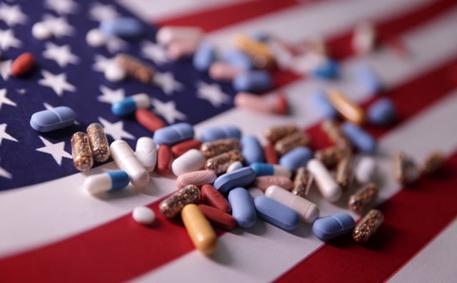 U.S. flag and medicines are seen in this illustration taken, June 27, 2024. REUTERS/Dado Ruvic/Illustration/File Photo