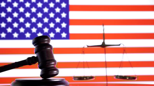 The U.S. flag, a judge gavel and a vintage scale are seen in this illustration taken August 6, 2024. REUTERS/Dado Ruvic/Illustration