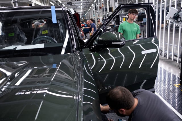 Workers assemble second-generation R1 vehicles at electric auto maker Rivian's manufacturing facility in Normal, Illinois, U.S. June 21, 2024.  REUTERS/Joel Angel Juarez/File Photo