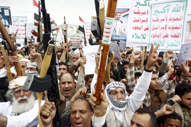 Yemenis brandish weapons, mock drones and chant slogans during a mass protest against U.S. airstrikes, which have reportedly killed civilians, and in solidarity with people in the Gaza Strip on May 2, 2025, in Sanaa.