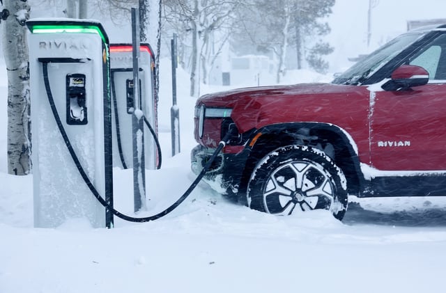 Rivian truck recharges at a Rivian electric vehicle charging station during a snowstorm on March 3, 2024 in Truckee, California.