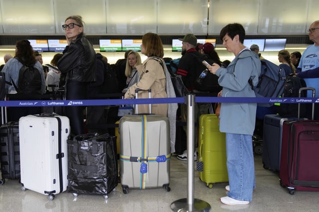 Travelers wait to check into their flights at Newark Liberty International Airport in Newark, N.J., Monday, May 5, 2025. (AP Photo/Seth Wenig)