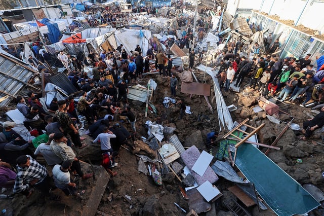 People search for survivors in the aftermath of an Israeli strike on a school compound in central Gaza on May 6, 2025.