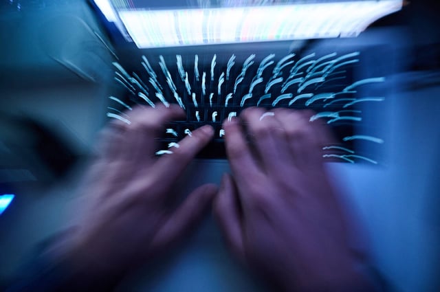 12 February 2023, Berlin: Illustration: Hands typing on a computer keyboard (zoom effect).