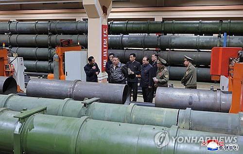 This photo, published by the Korean Central News Agency on May 7, 2025, shows North Korean leader Kim Jong-un (2nd from L, front) inspecting a munitions factory. (For Use Only in the Republic of Korea. No Redistribution) (Yonhap)