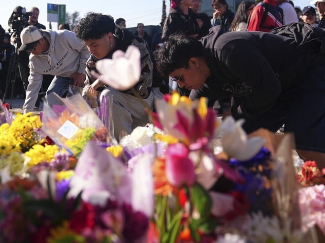 Visitors pay their respects at a memorial for the Lapu Lapu Day victims in Vancouver on Sunday, April 27, 2025.