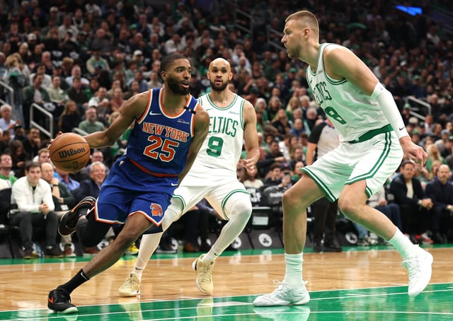 BOSTON, MASSACHUSETTS - MAY 05: Mikal Bridges #25 of the New York Knicks drives the ball against Kristaps Porzingis #8 of the Boston Celtics during the first quarter in Game One of the Eastern Conference Second Round NBA Playoffs at TD Garden on May 05, 2025 in Boston, Massachusetts. NOTE TO USER: User expressly acknowledges and agrees that, by downloading and or using this photograph, User is consenting to the terms and conditions of the Getty Images License Agreement. (Photo by Maddie Meyer/Getty Images)
